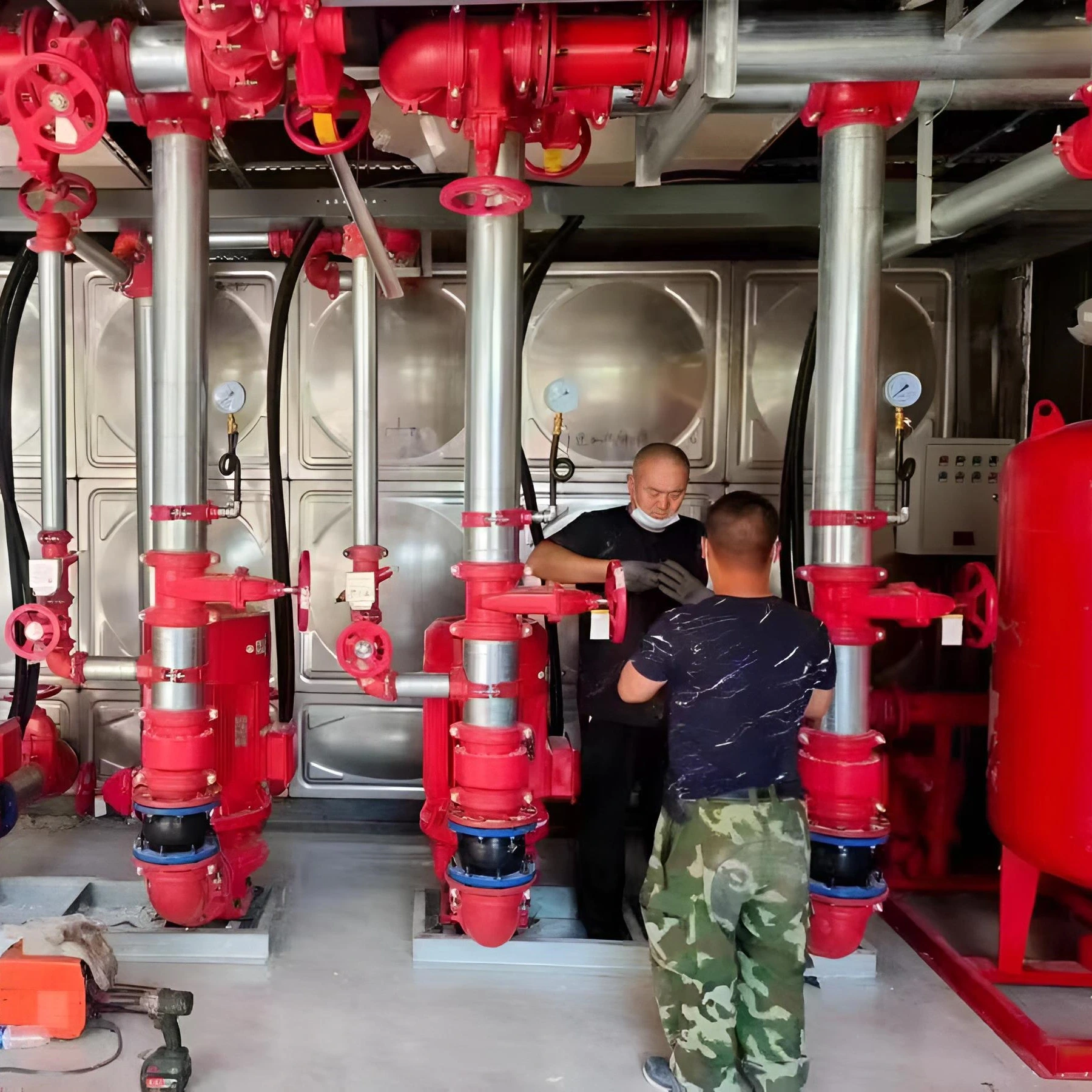 Workers-installing-expansion-joint-rubber-bellow-on-site